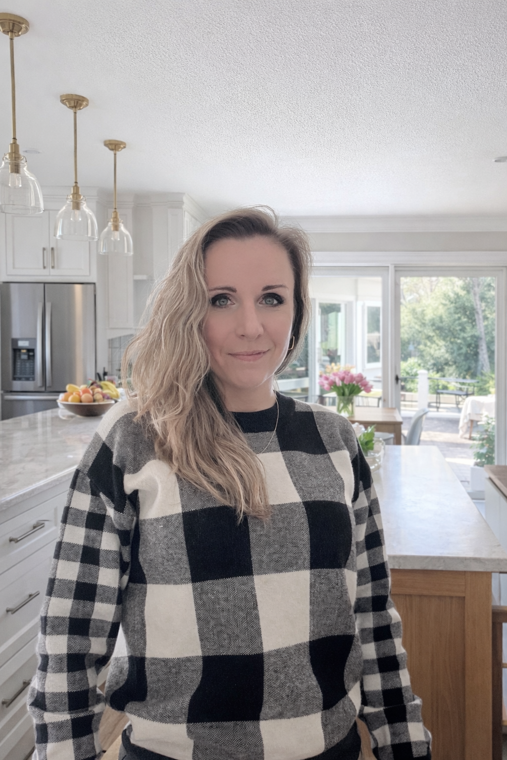 Hand-pouring soy candles in Connecticut by Candle Club Company founder in bright modern kitchen