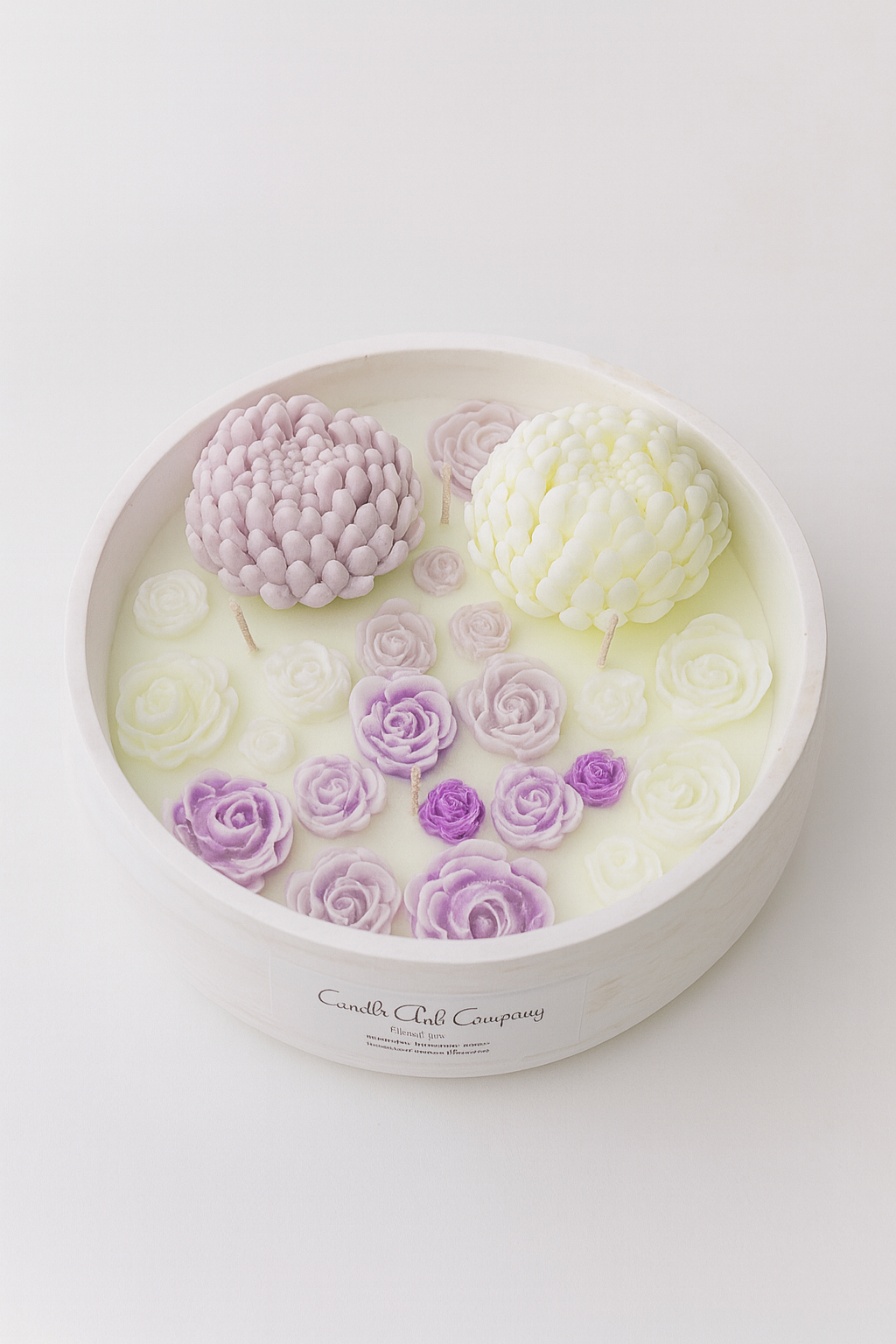 "Handcrafted floral bowl candle by Candle Club Company featuring detailed lavender, white, and purple rose wax flowers arranged in a round white vessel; artisanal soy candle made in Connecticut and shipped across the USA."