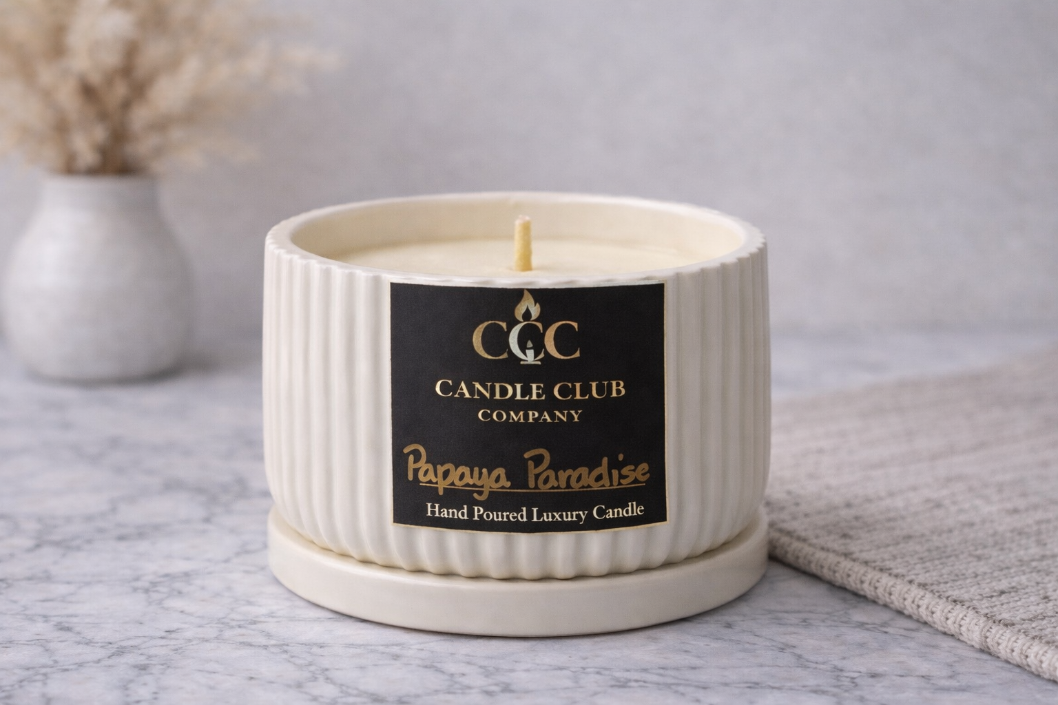 Close-up of luxury soy candle with minimalist ribbed vessel and Candle Club Company label, clean-burning candle