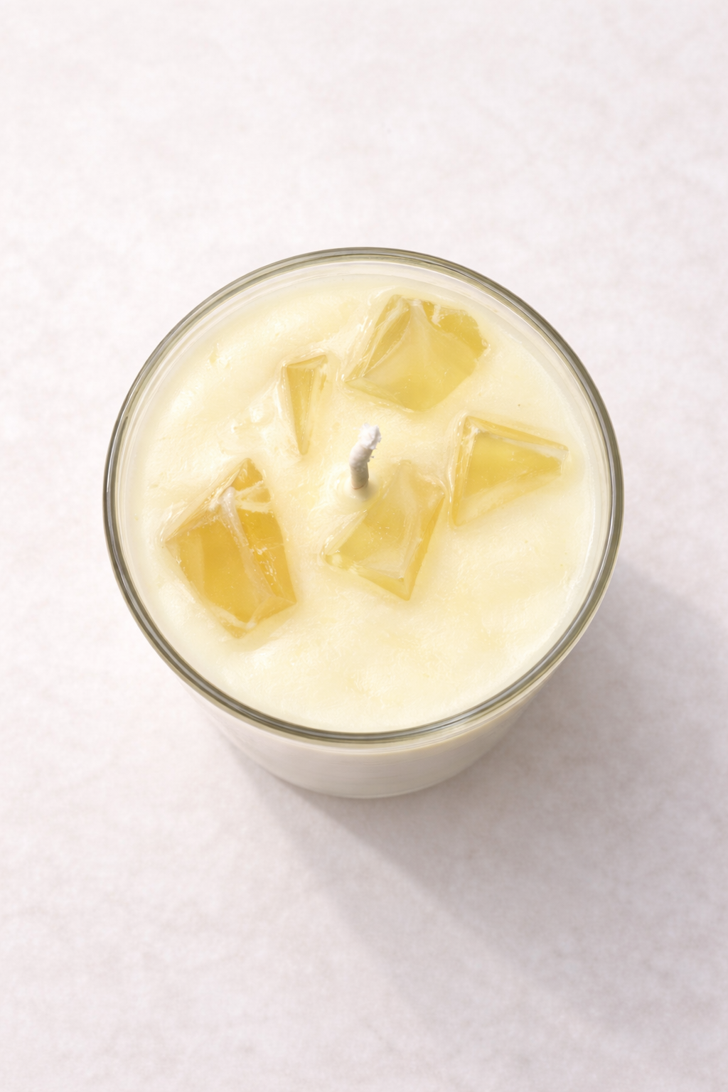 “Top view of Piña Colada soy candle with decorative wax detail and cotton wick”