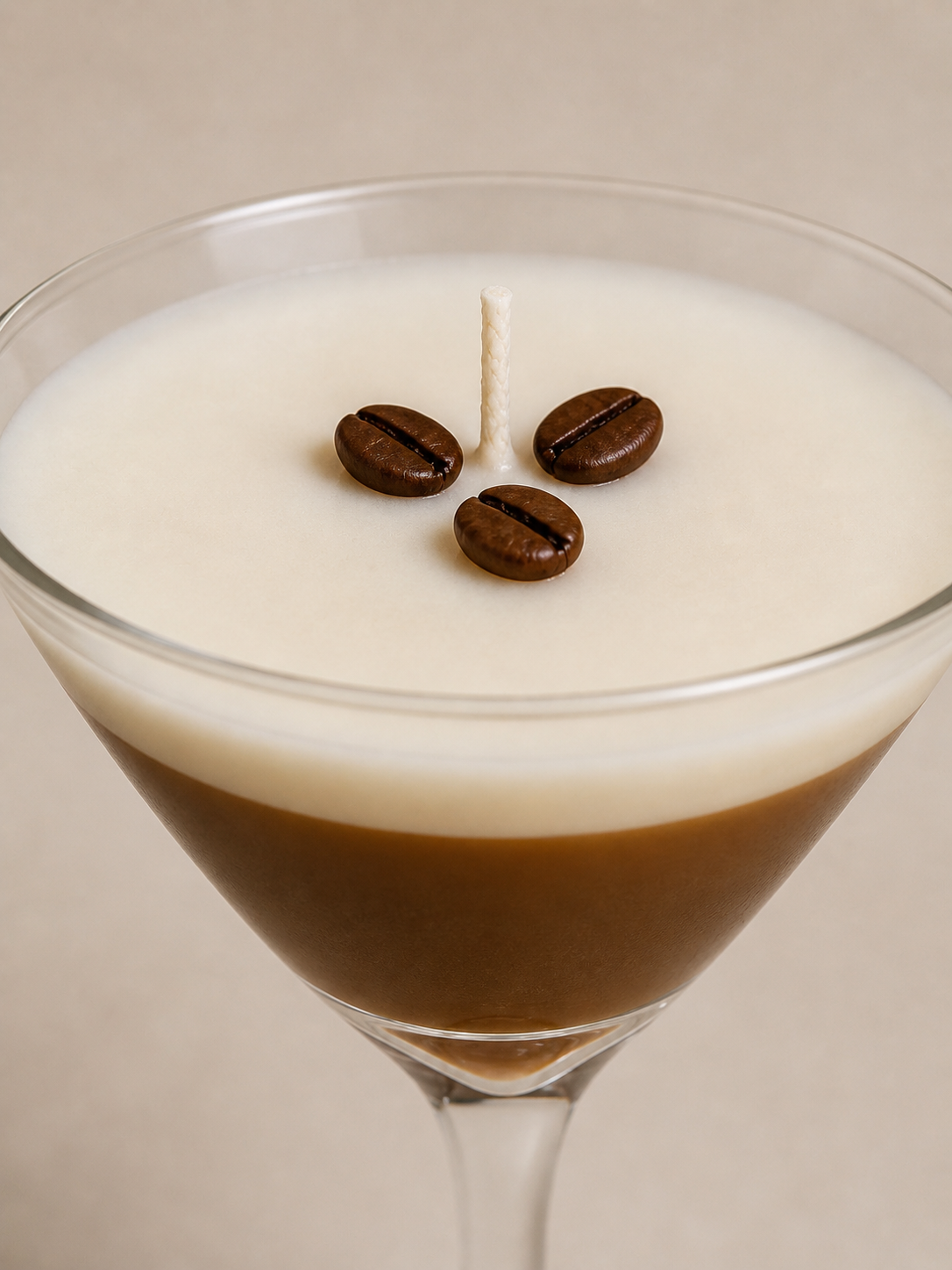 Close-up of espresso martini candle showing creamy white wax top with coffee bean details and centered cotton wick.