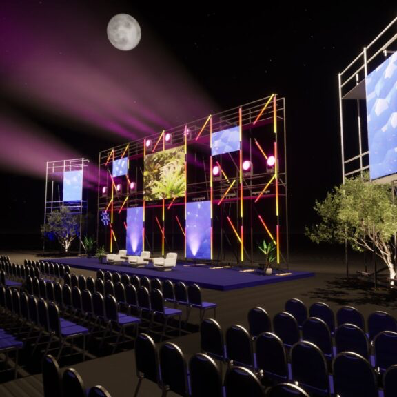 Outdoor stage setup at night with a full moon, multiple screens, purple and pink lighting, seating area, and some small trees.