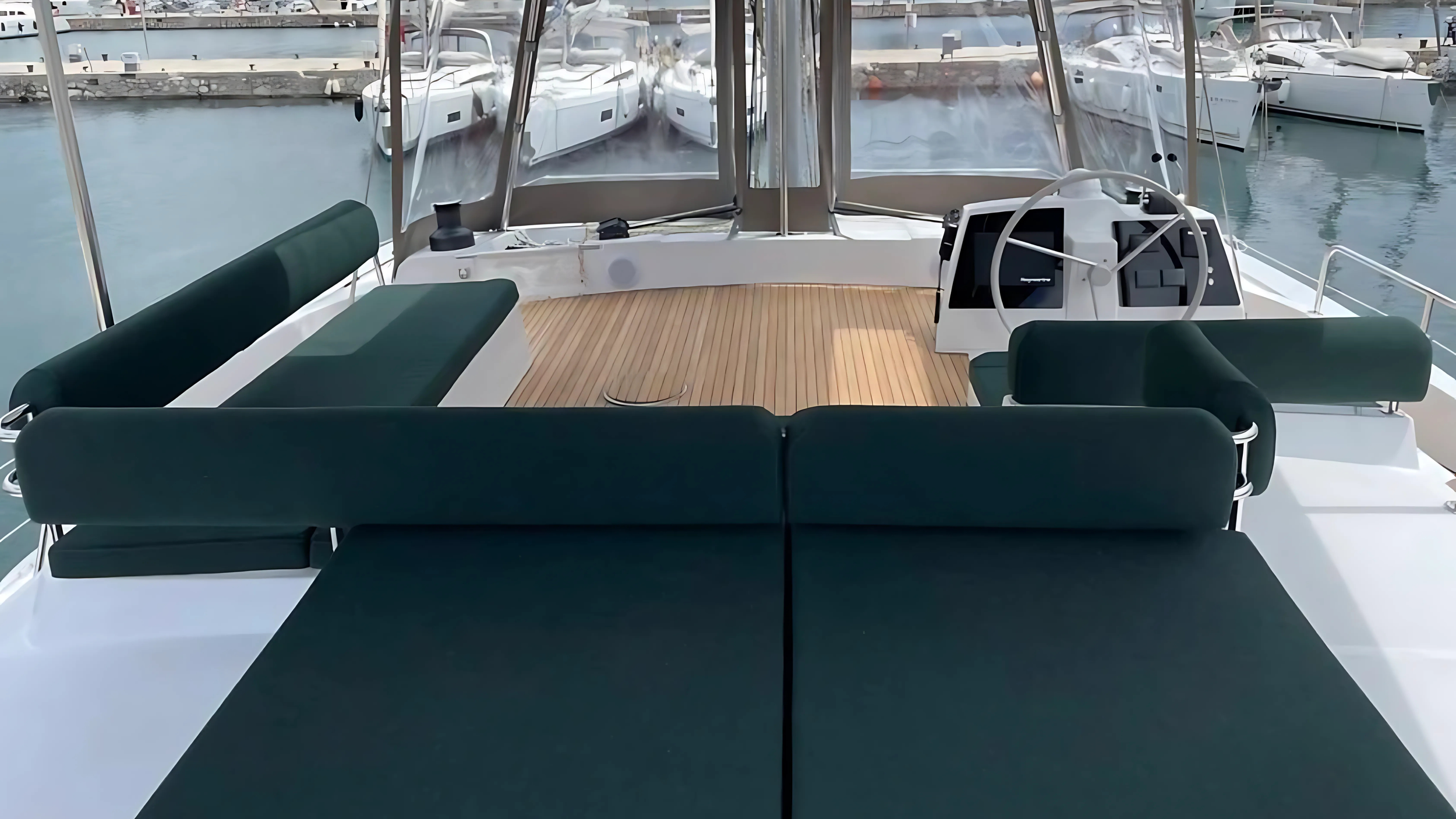 interior view of a yacht with cushioned seating and steering wheel