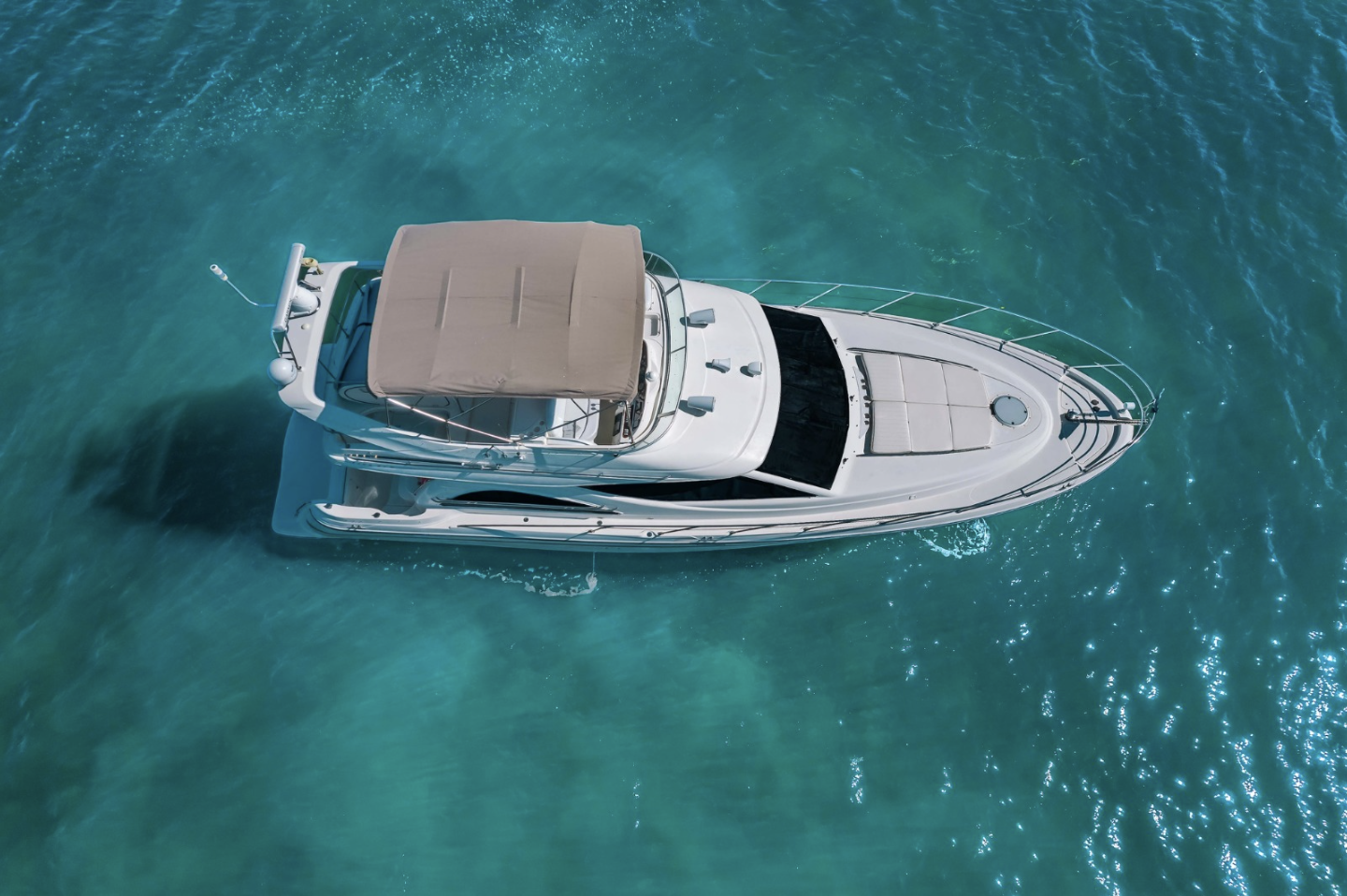 Aerial view of a yacht in clear blue water