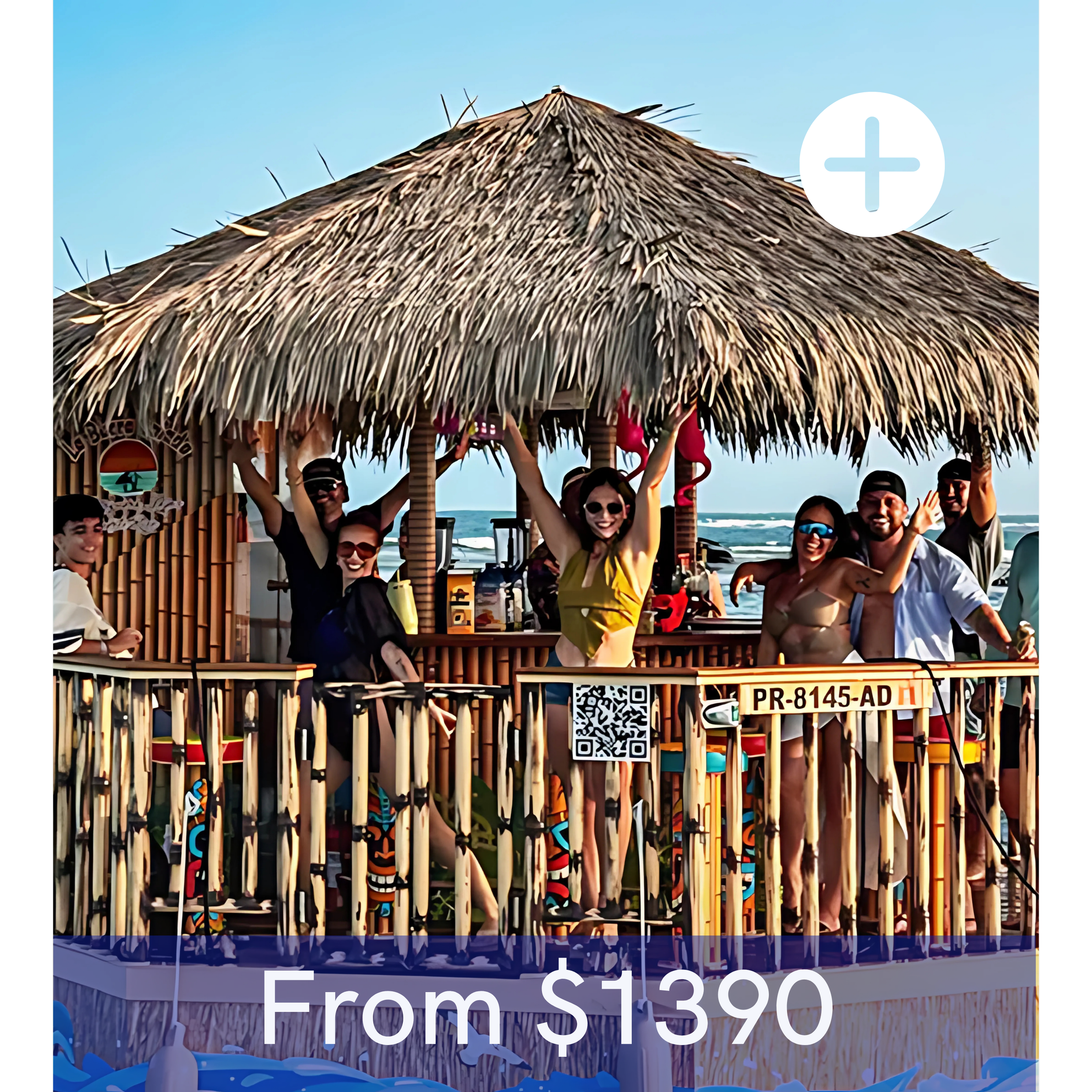 Group of people smiling and waving on a beachside tiki bar with thatched roof, ocean in background, during daytime.