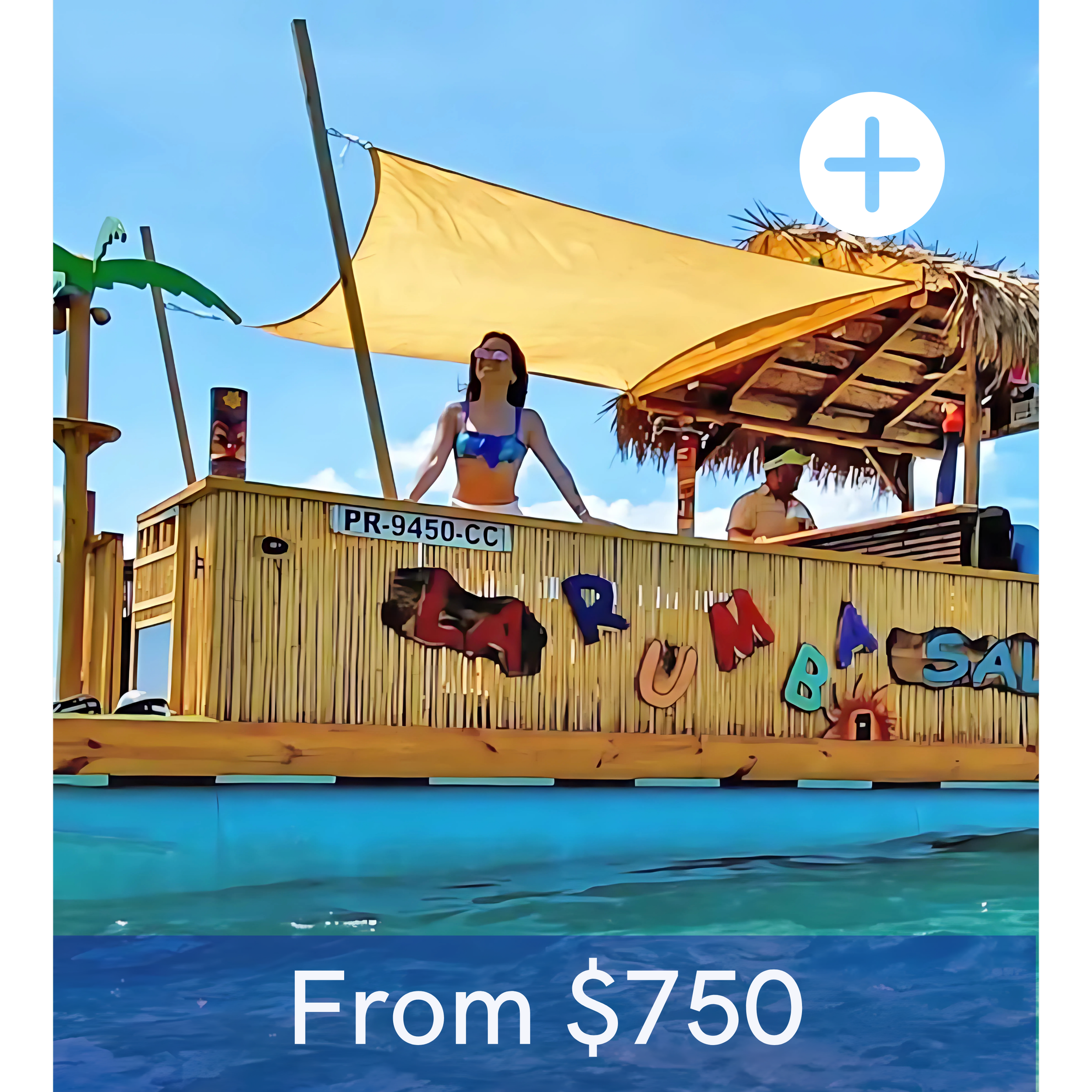 A floating bar with a thatched roof and colorful letters spelling Paula's Bar, with a woman in a blue swimsuit standing behind the counter and a man in a yellow shirt and cap sitting nearby, over water under a blue sky.