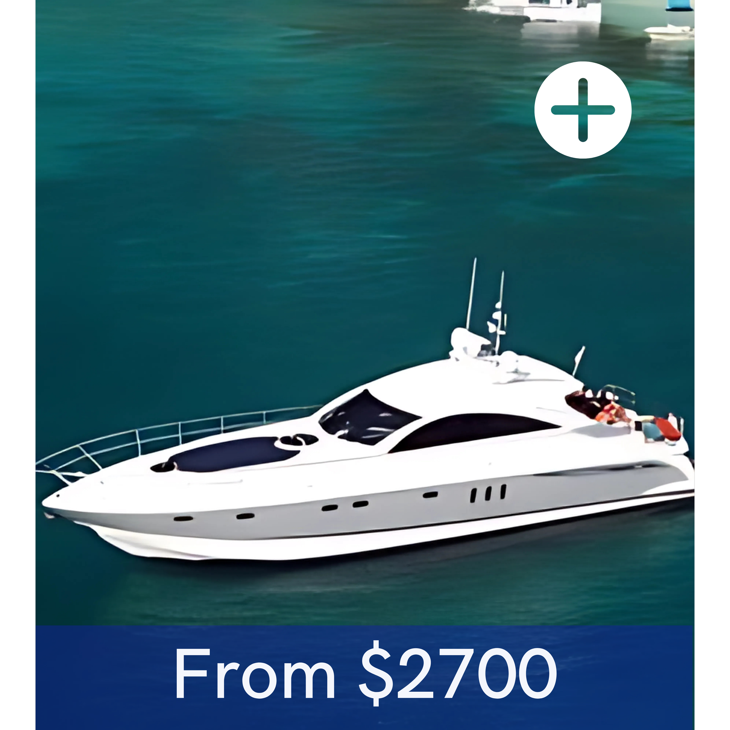 A white yacht floating on calm water with a dock visible in the background.