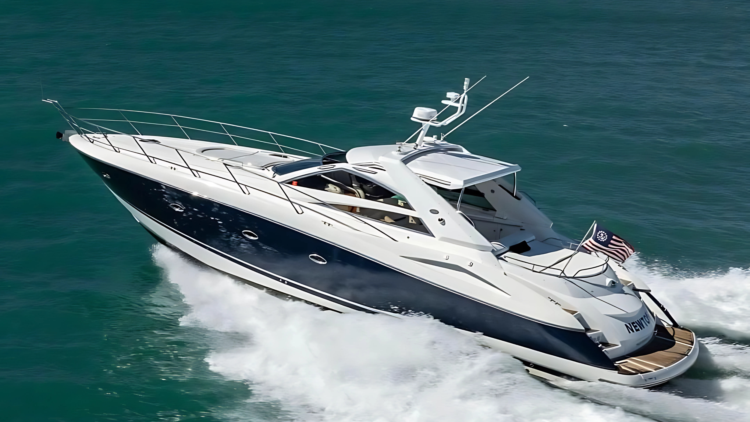 Luxury motor yacht cruising on the ocean with American flag