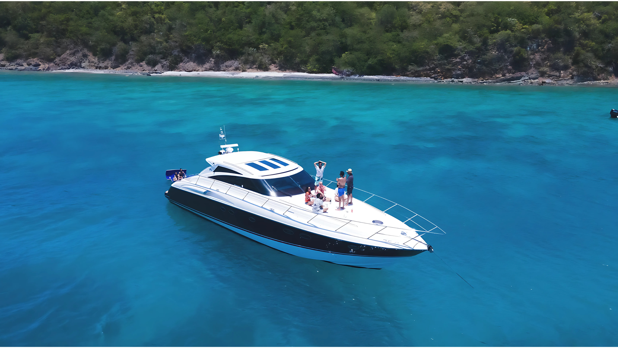 Luxury yacht in clear blue water near a tropical island.