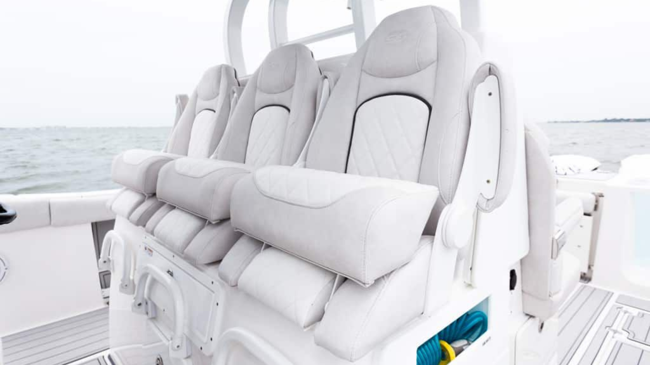 luxury boat seating with white cushioned seats on a boat deck