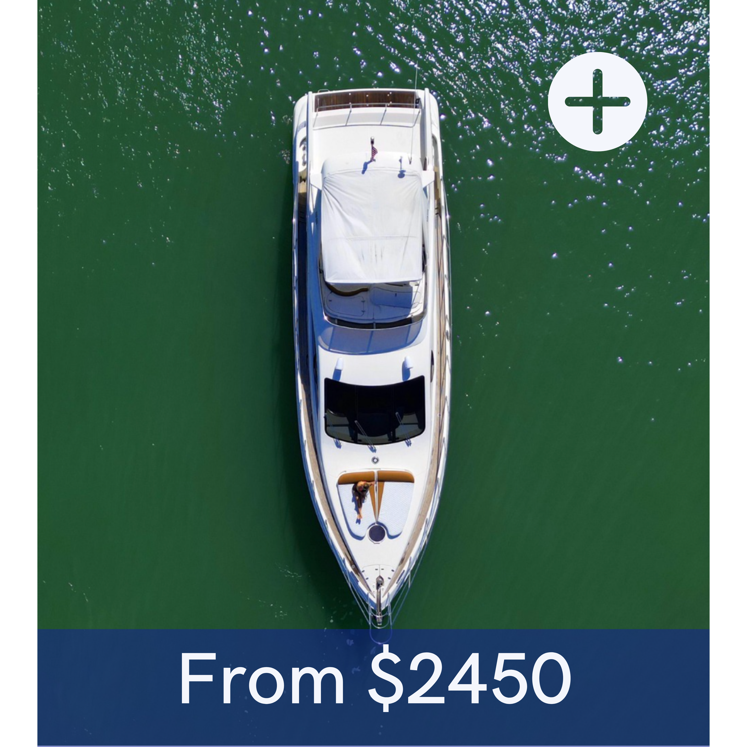 Aerial view of a white yacht on green water with a person on deck and a surfboard, with the text "From $2450" overlayed at the bottom.