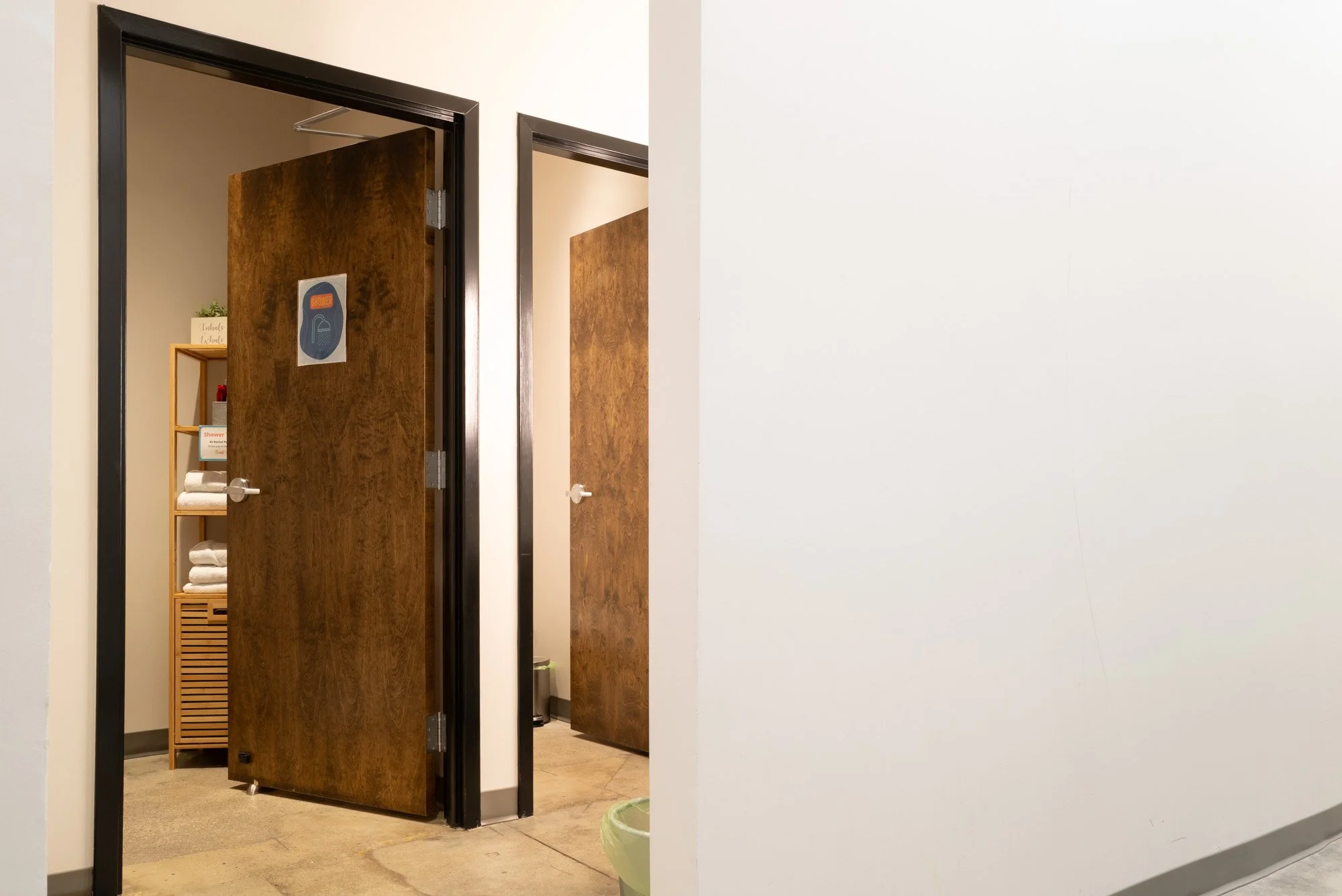 hallway restroom bathroom with shower sign 