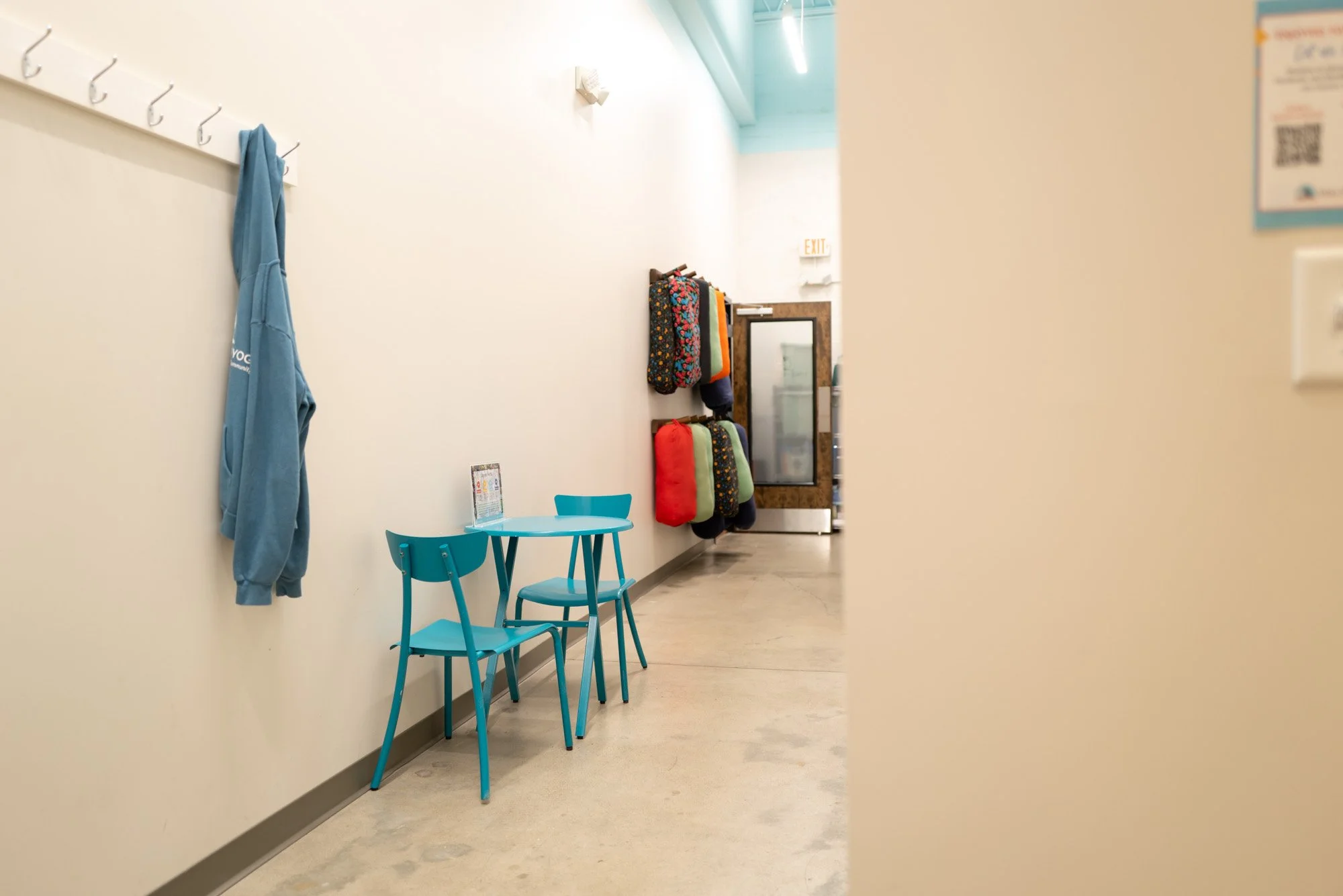 seating area in a hallway with a coatrack