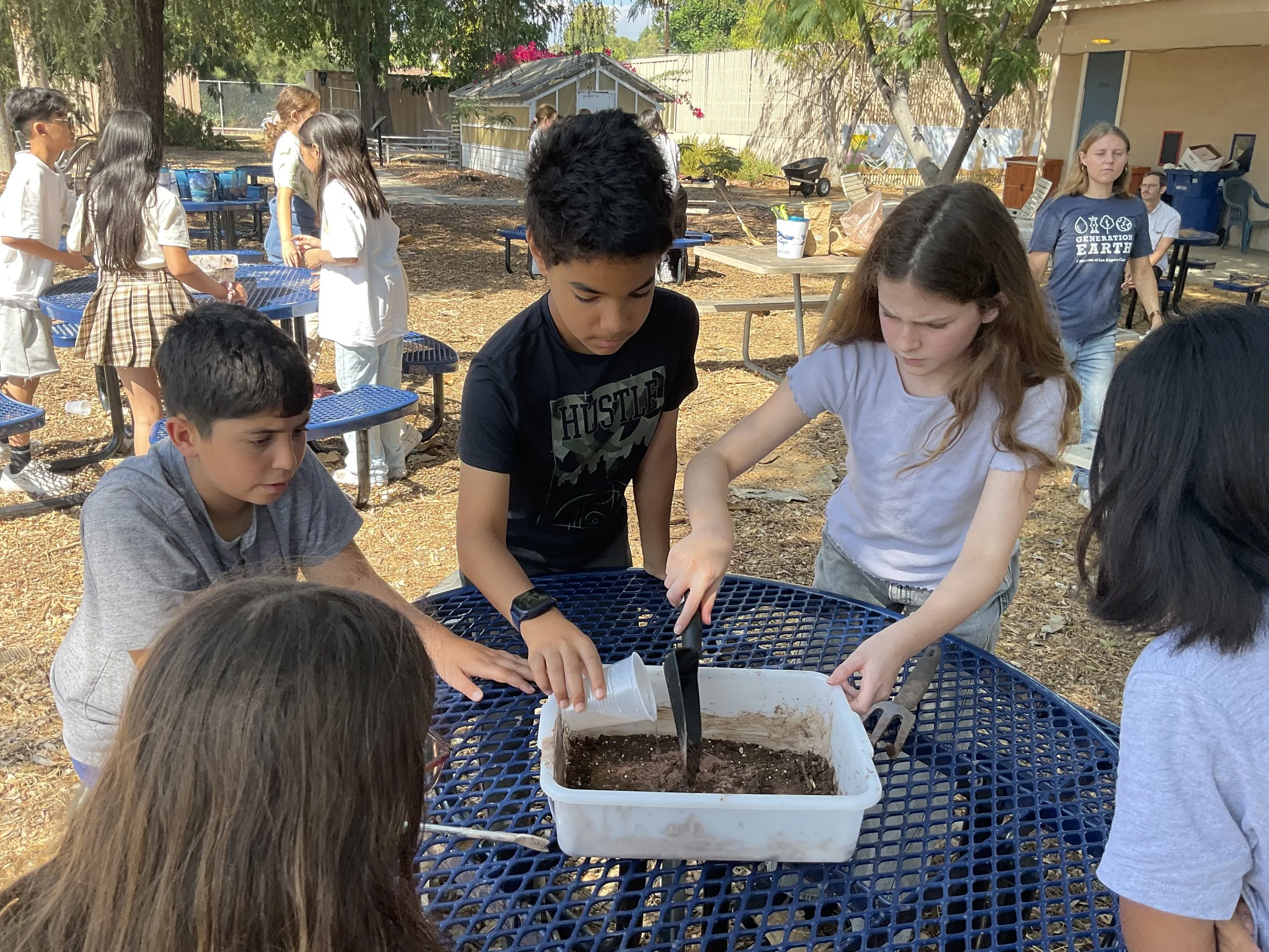 Making seed balls with native plant seeds..