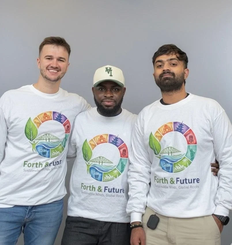 Three men wearing white long-sleeve shirts with colorful circular logo and the words 'Forth & Future' stand in front of a plain gray wall. The logo features leaves, bridges, lakes, and various symbols inside the circle.
