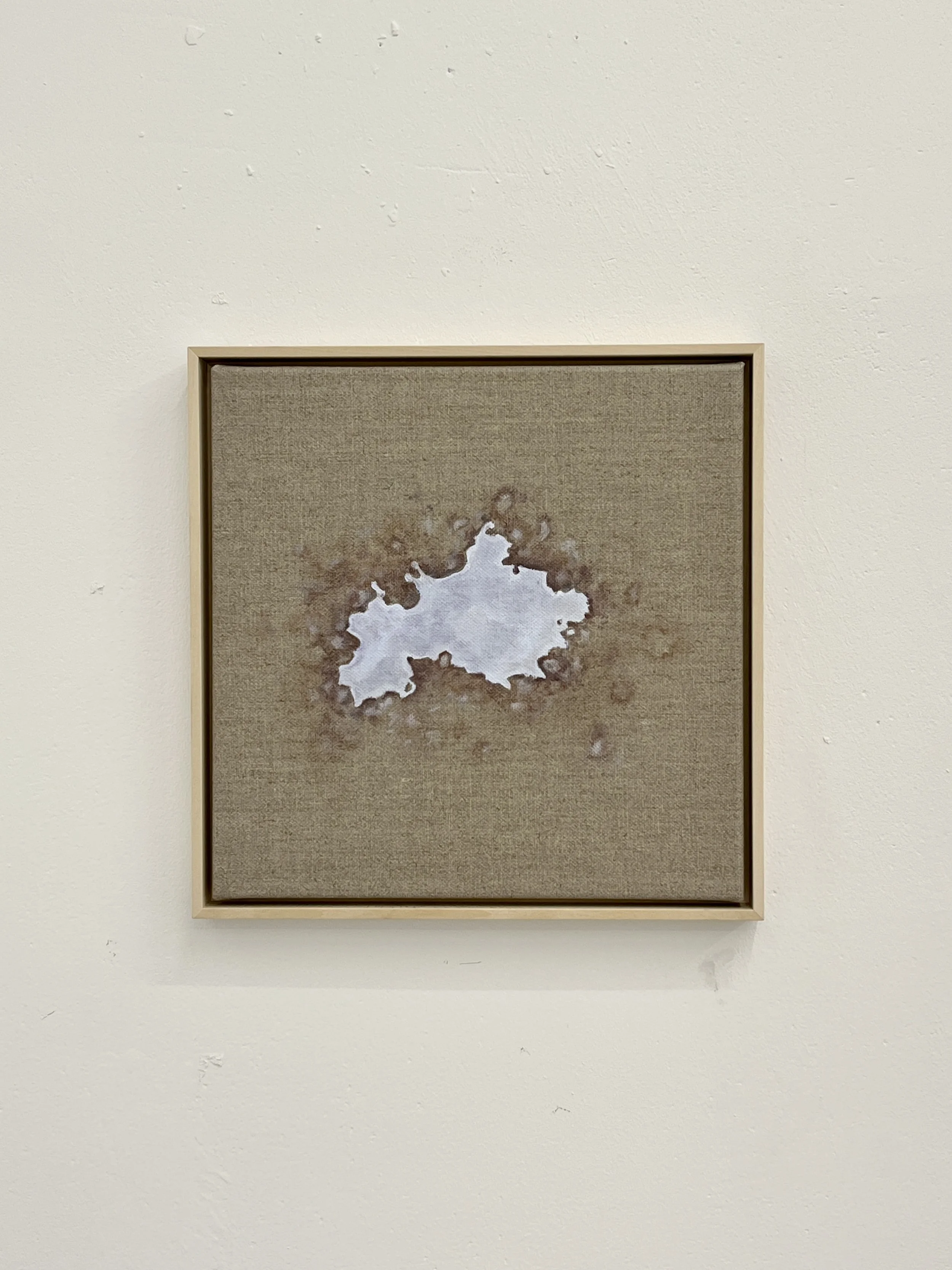 Abstract artwork of a white and gray form on a textured beige background with a simple quadrangle wooden frame.