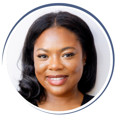 Close-up portrait of a smiling Black woman with shoulder-length black hair, wearing a black top.