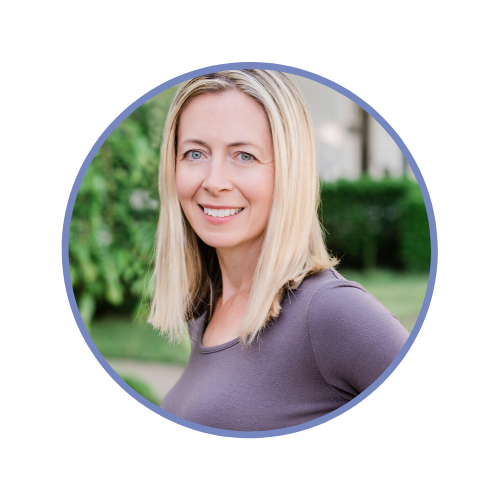 A smiling woman with shoulder-length blonde hair, wearing a purple top, outdoors with greenery in the background.