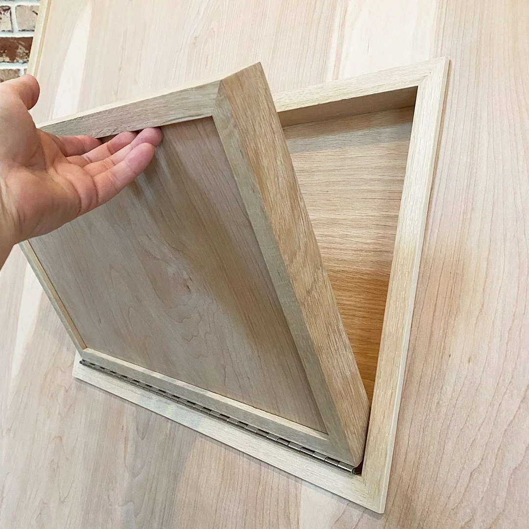 The hidden cedar compartment built into the back of every Lisa Jane heirloom story art frame, housing the hand-stitched Written Story book.