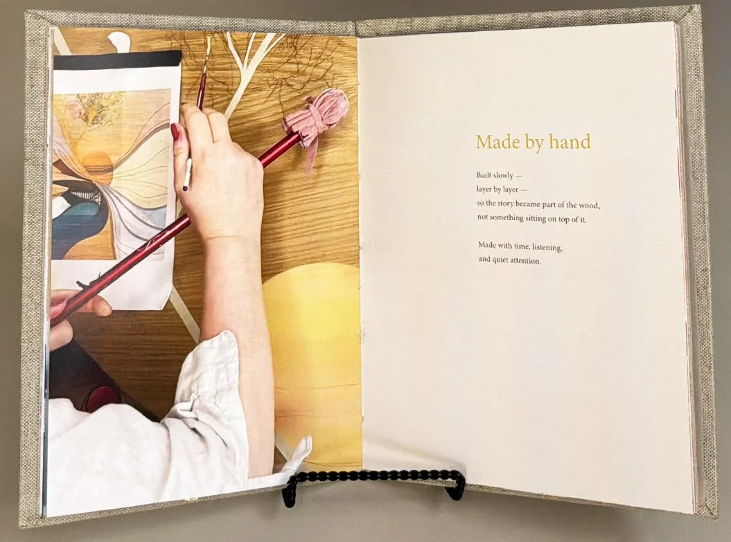 The Written Story book — hand-stitched, linen-bound, and housed inside the painting's frame. Part of every Lisa Jane heirloom story art commission.