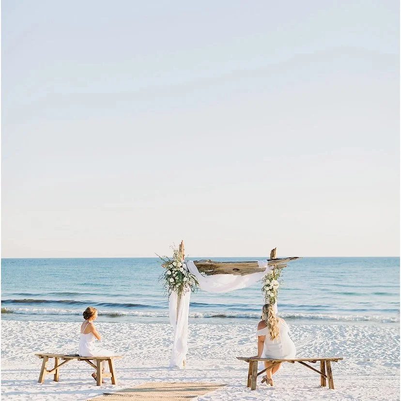Bridesmaids sitting at the alter of a destination beach wedding by Defining Moments Special Events