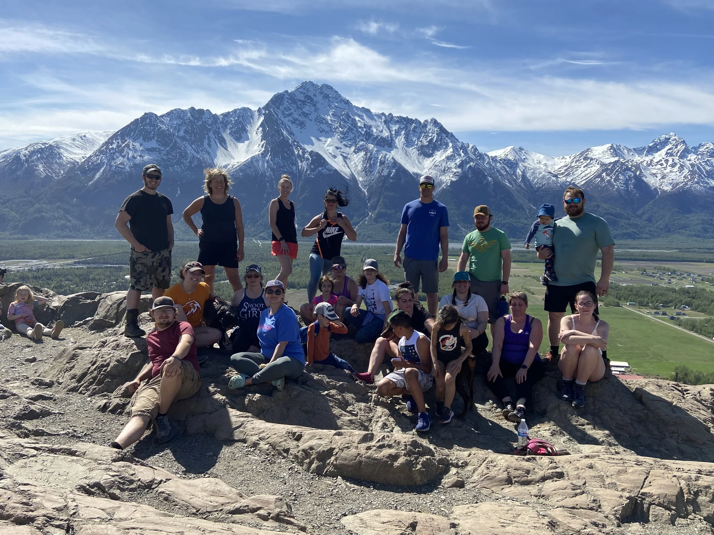 group of people standing on a mountain