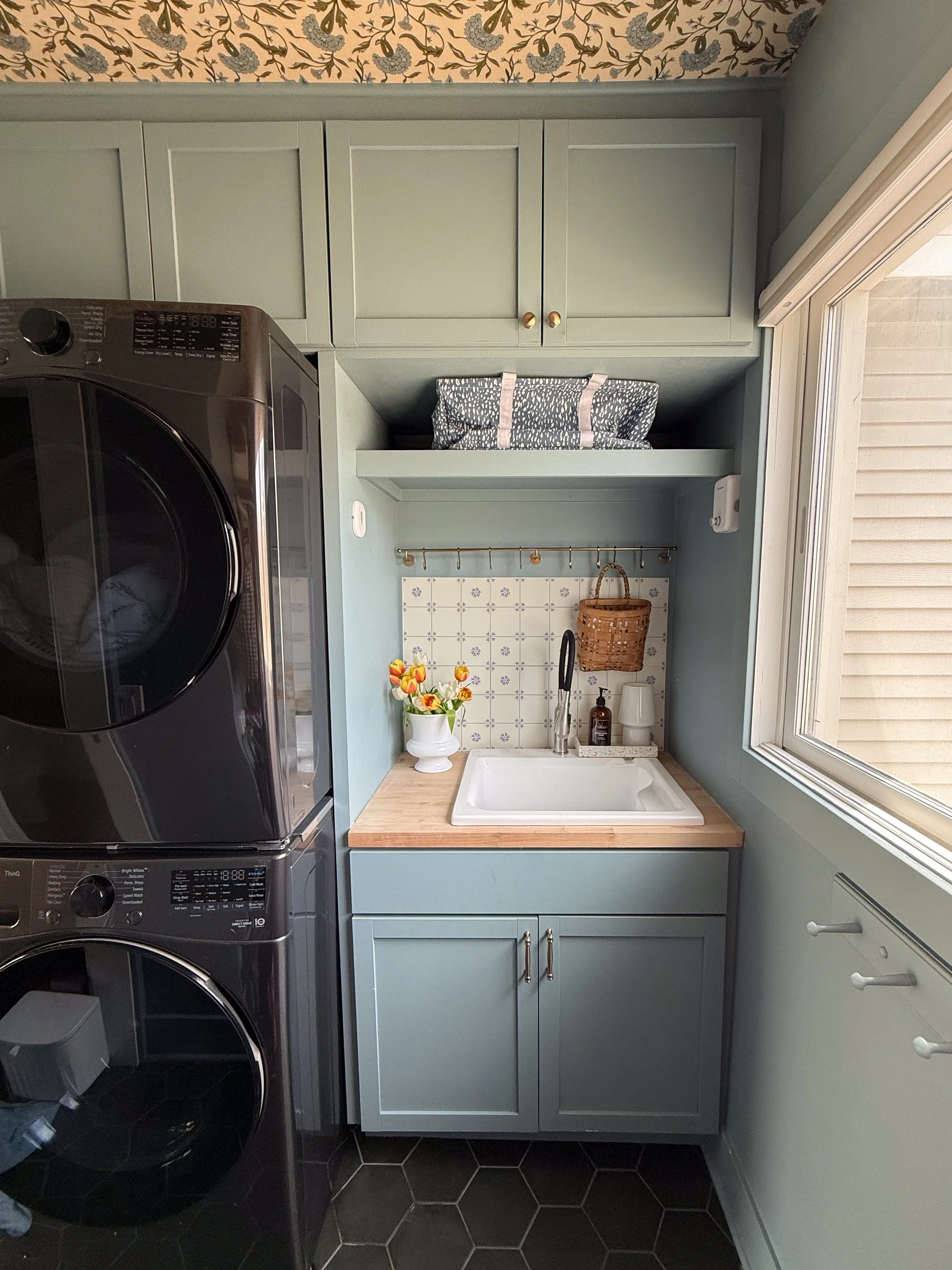 Laundry room with blue cabinets