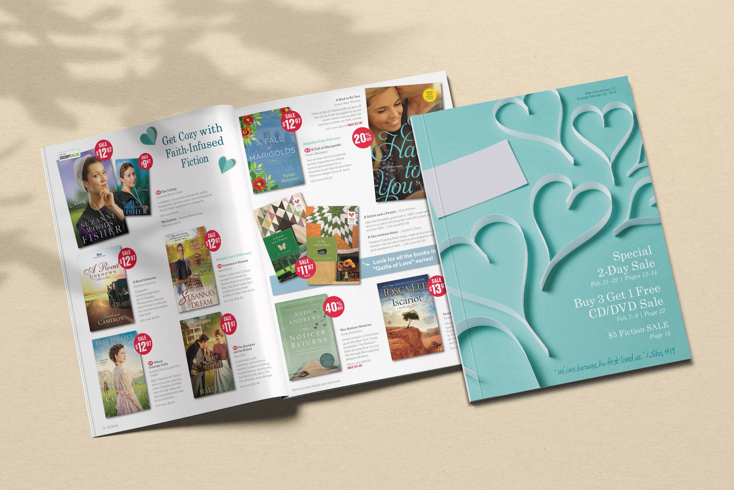 Open magazine with book advertisements and a closed booklet with heart shapes on the cover, placed on a beige surface.