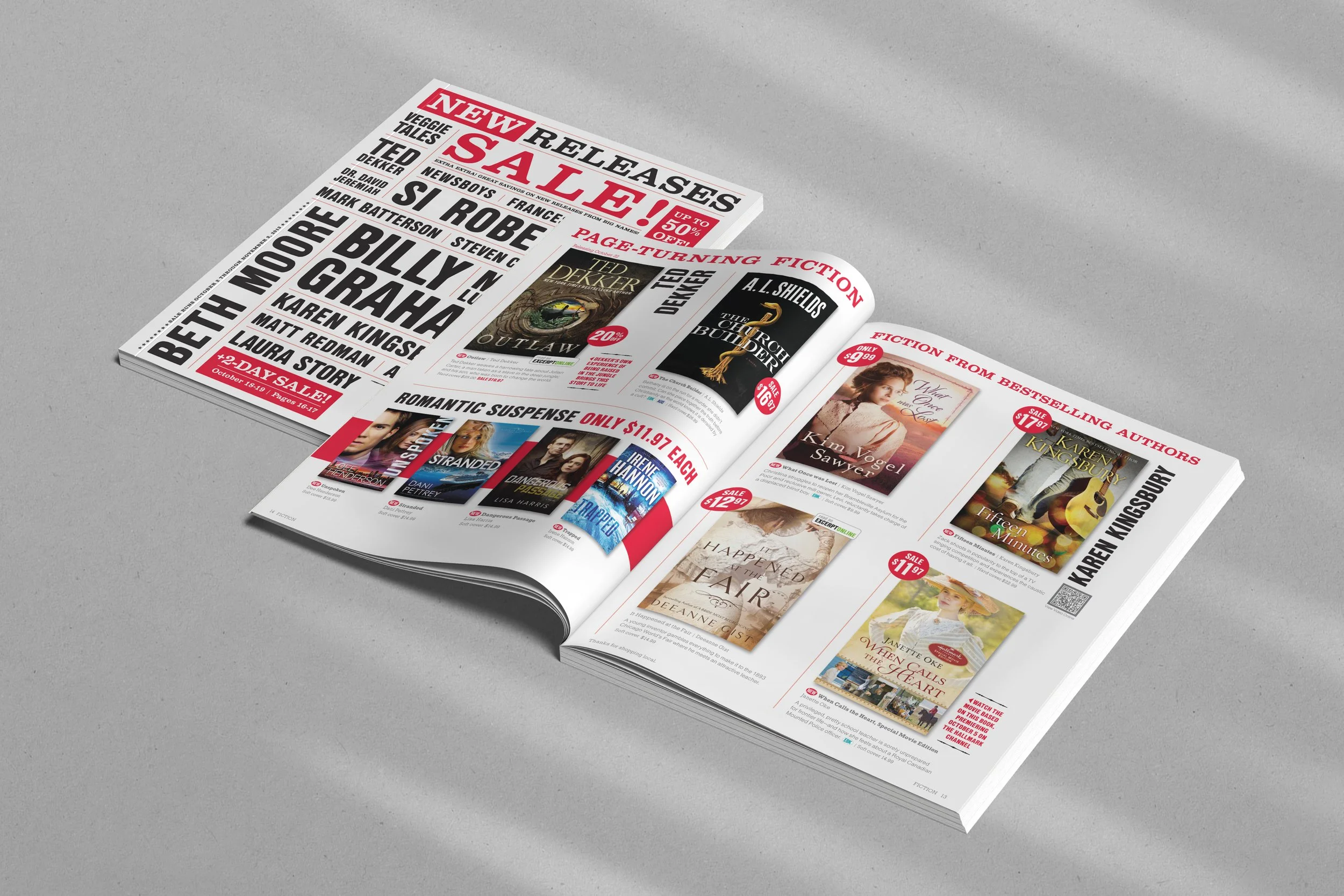 Open newspaper laying on a gray surface displaying book sale advertisements, book titles, cover images, and prices.