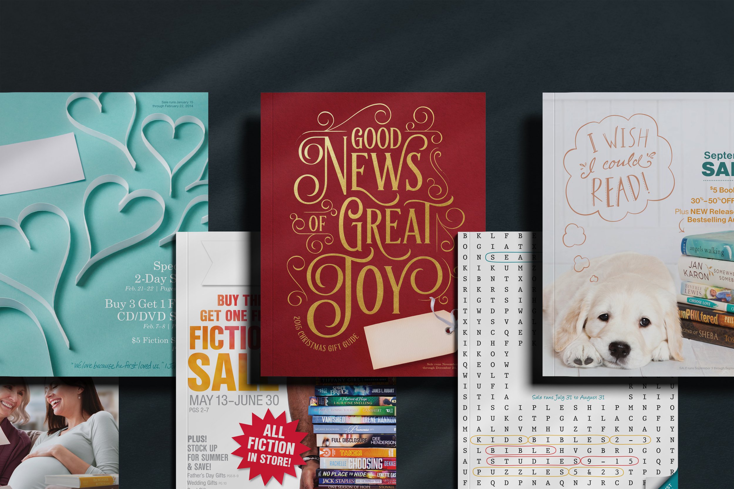 Collection of Christmas and holiday gift guides, including books, with a red cover titled 'Good News of Great Joy' and a white dog with a speech bubble that says 'I wish I could read!'