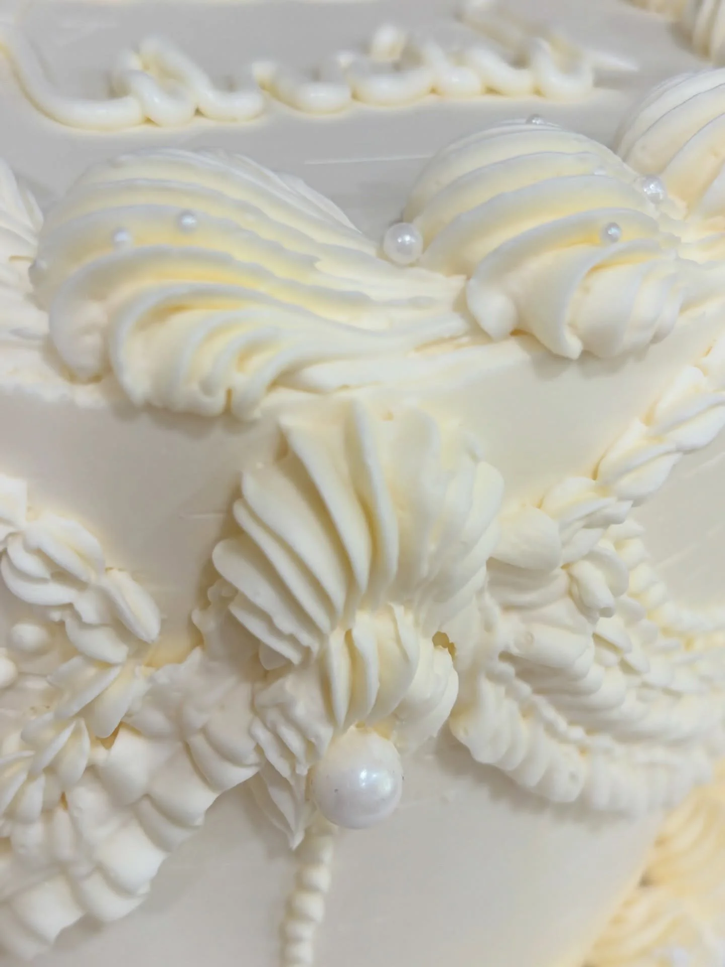Sneak peak: this is your wedding cake.
She&rsquo;s filled with your absolute favorites and smothered in white chocolate buttercream. She&rsquo;s covered in edible pearls and you&rsquo;ll dive into her with your future forever person. 
The perfect for