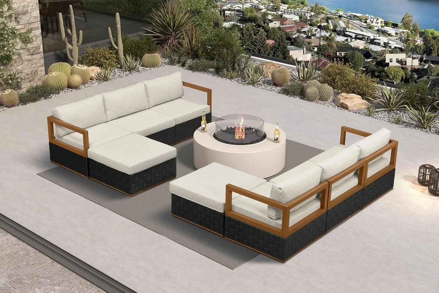 Outdoor patio with sectional sofa around a fire pit, overlooking a desert landscape with cacti and a city view in the background.