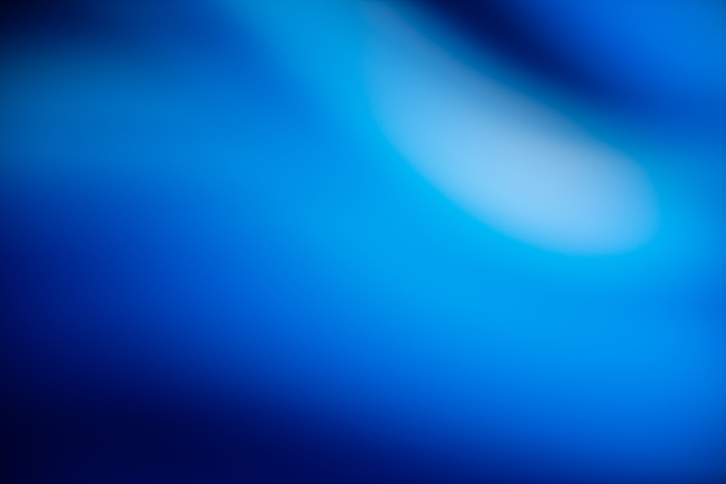 Abstract blue blurred background with smooth gradients.