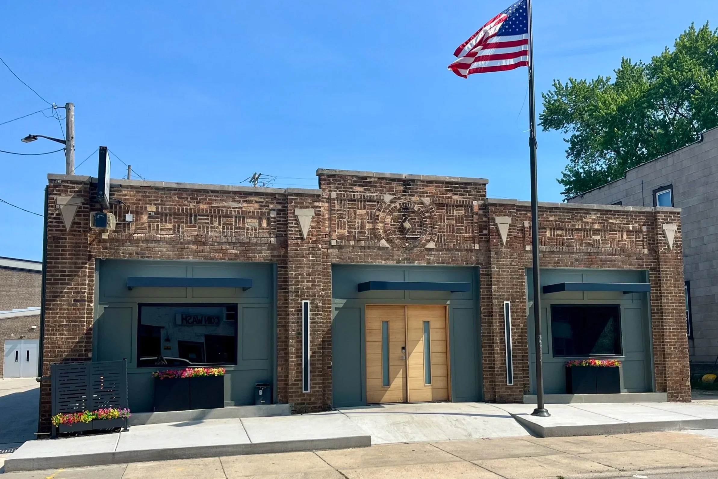 Laurie’s customers, Mariana and Carmen holding hands on a green lawn on their wedding day.