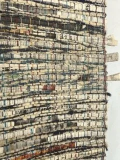Close-up of tall, densely packed stacks of books arranged vertically.