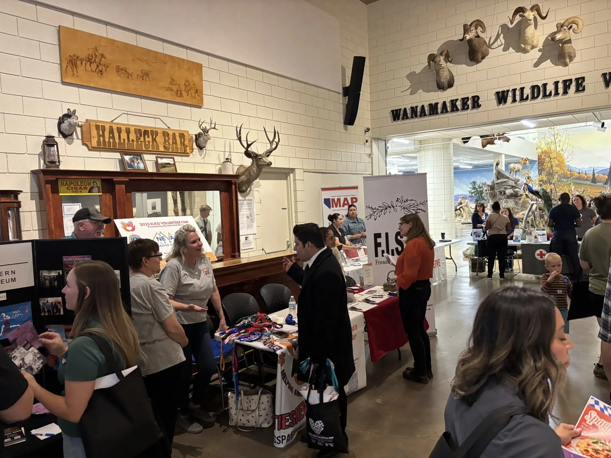 F.I.S.H. staff and volunteers speak with community members at a local volunteer fair.