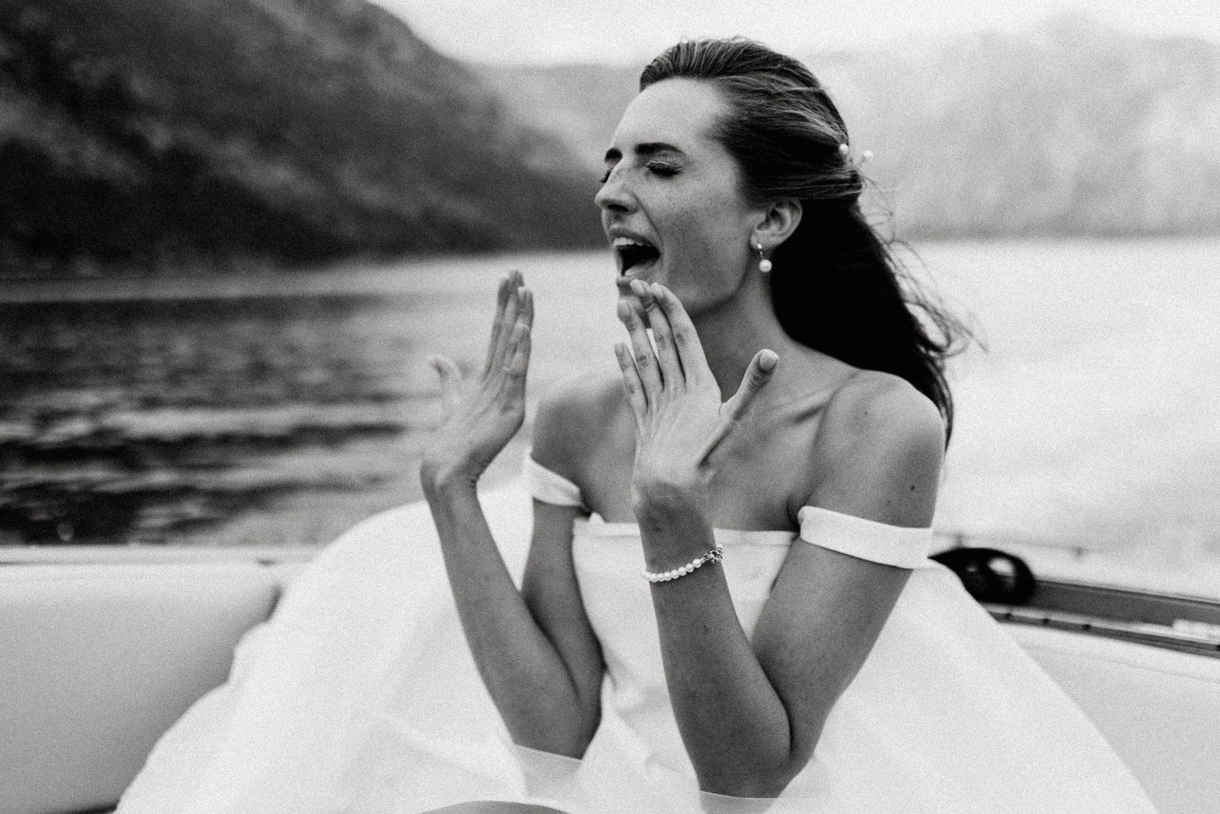Bride overcome with emotion on a boat in Kotor Bay, Montenegro — documentary wedding and elopement photography by The Wed Wild