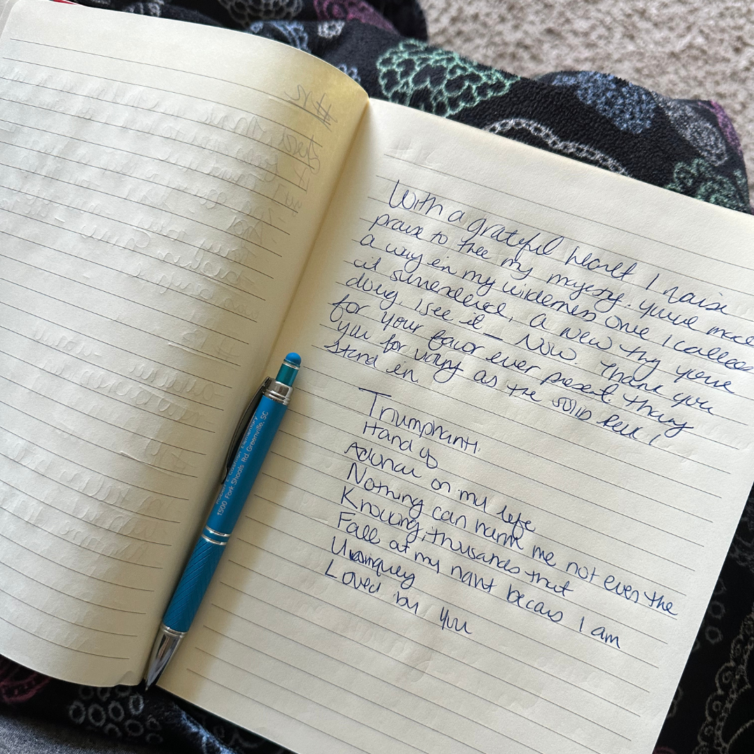 Open notebook with handwritten gratitude and triumph notes, with a blue pen resting on the page.