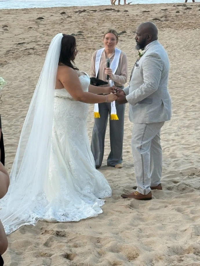 Paradise Vows PR owner Kendra smiling and marrying a couple on the beach.