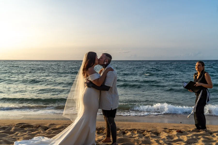 Intimate beach elopement ceremony in Puerto Rico featuring the couple's first kiss near the Caribbean Sea.