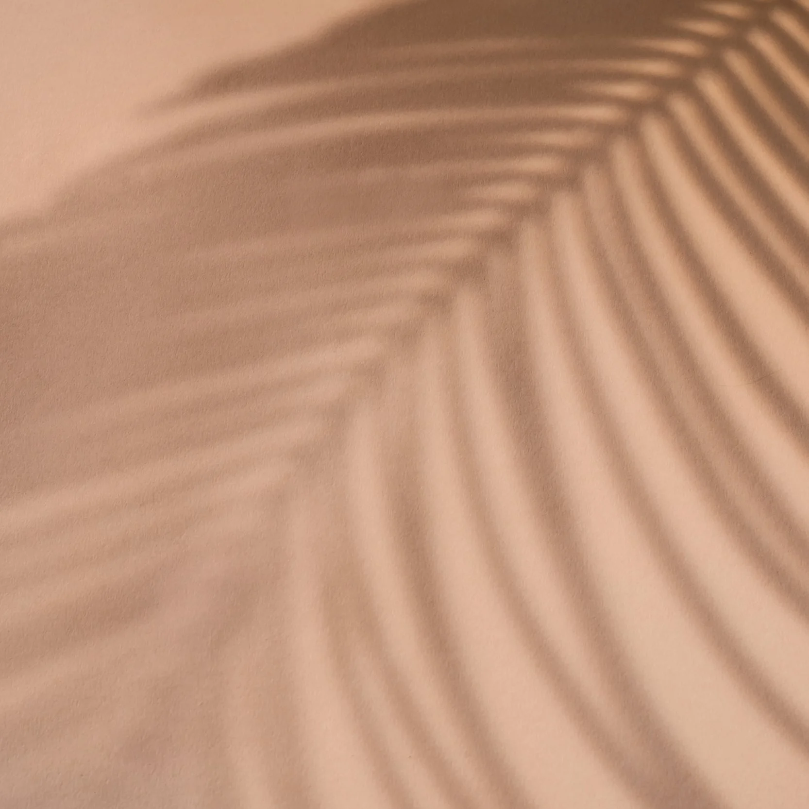 Close-up of a textured surface with shadows creating a pattern of diagonal lines.