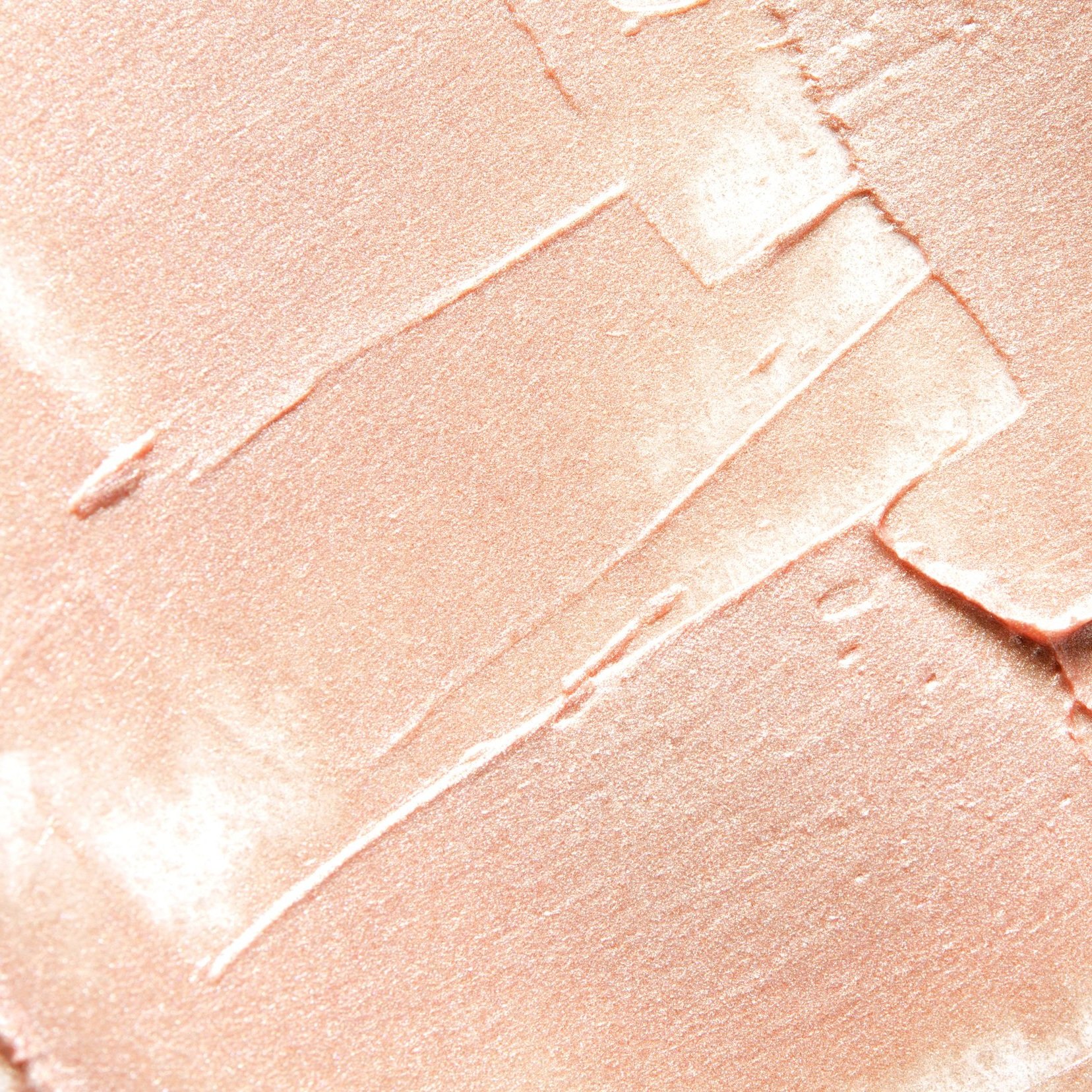 Close-up of a smooth, peach-colored substance with visible knife marks.