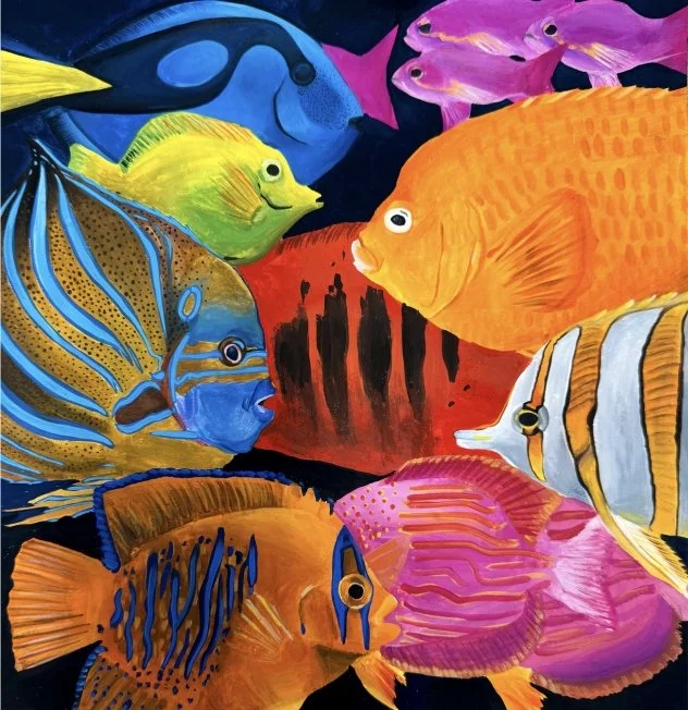 Colorful array of tropical fish including yellow, blue, orange, pink, and striped species swimming together against a dark background.