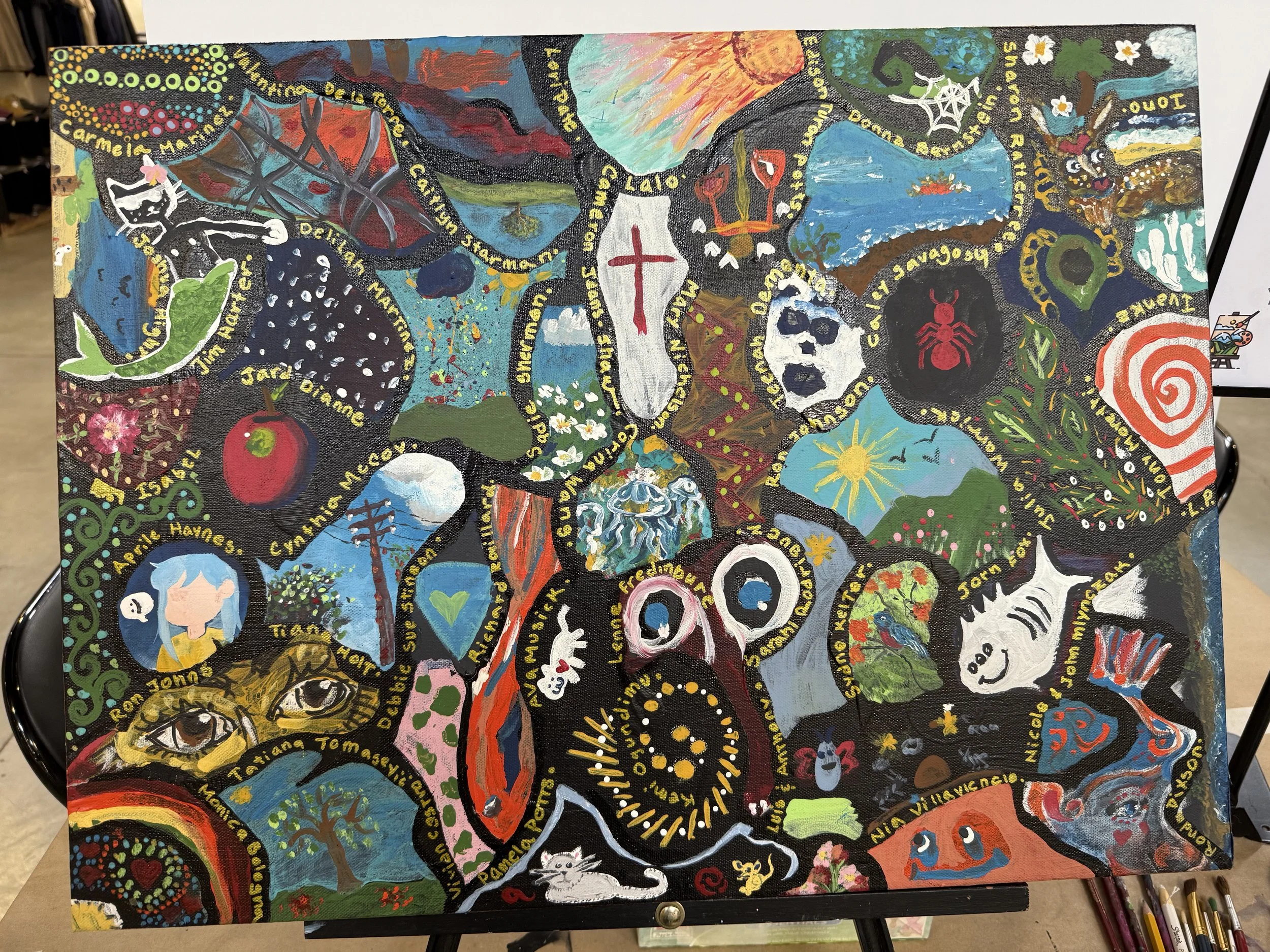 Colorful abstract painting with various images including a black cat, apple, whale, skeleton, spider, owl, human faces, and nature scenes, all interconnected with yellow text written in swirls.