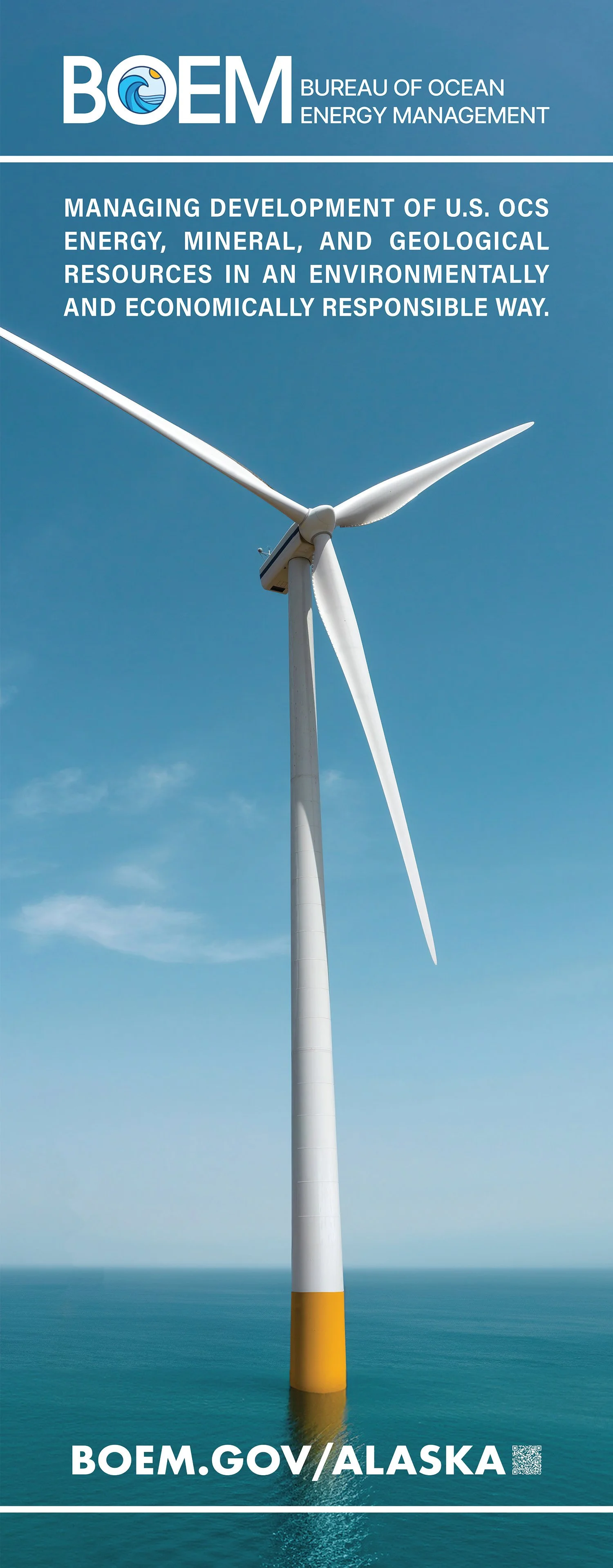 A large white wind turbine standing in the ocean with a clear blue sky in the background.