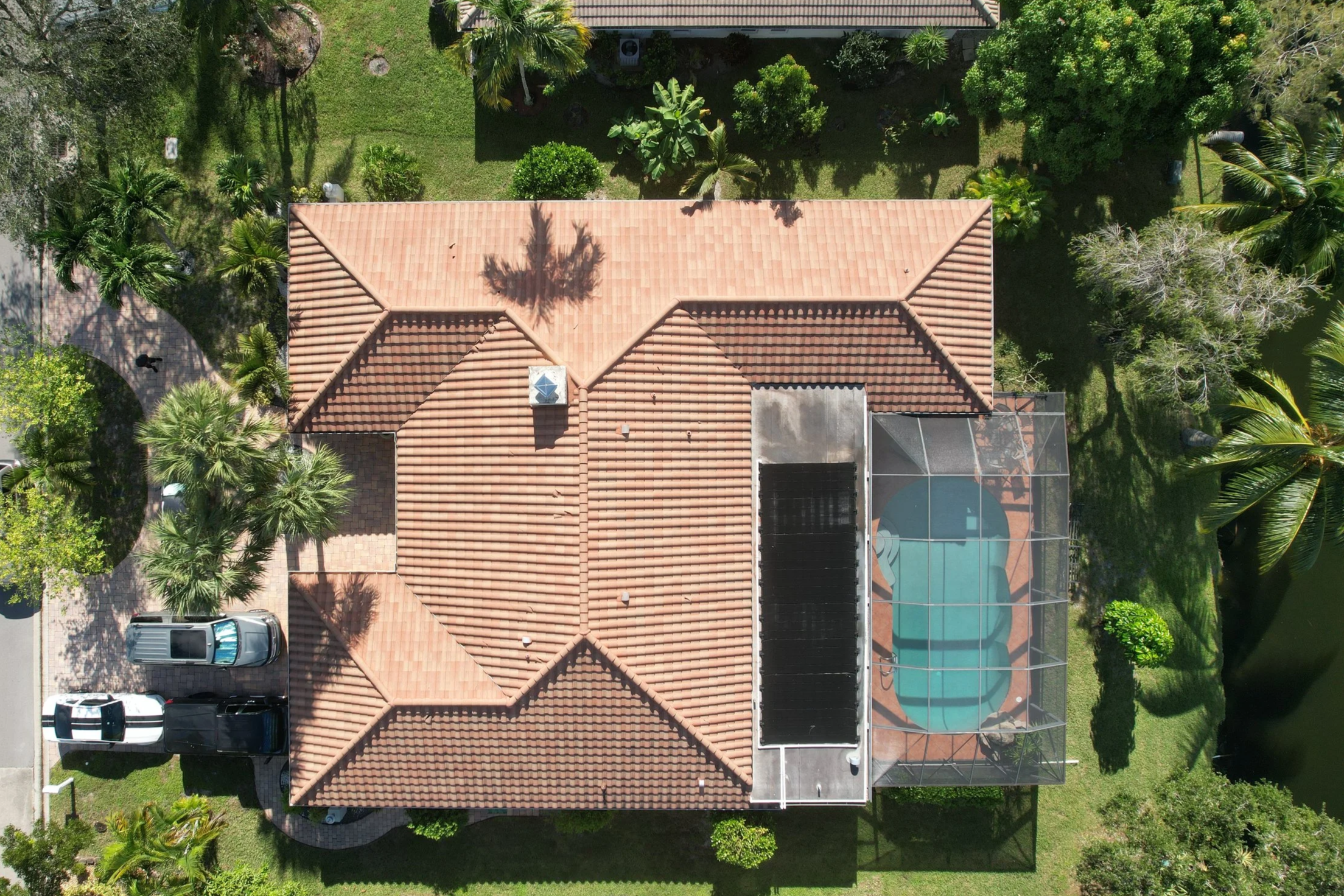 Aerial roof inspection and pool view captured by FlyTactix drone -South Florida residential property imaging.