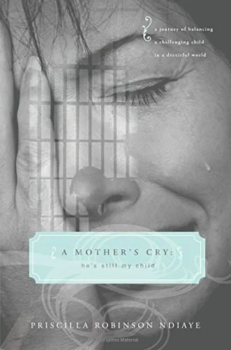 Close-up of a mother crying with her face pressed against jail bars, overlayed with text about a mother's cry and a book cover titled 'A Mother's Cry' by Priscilla Robinson Ndiaye.