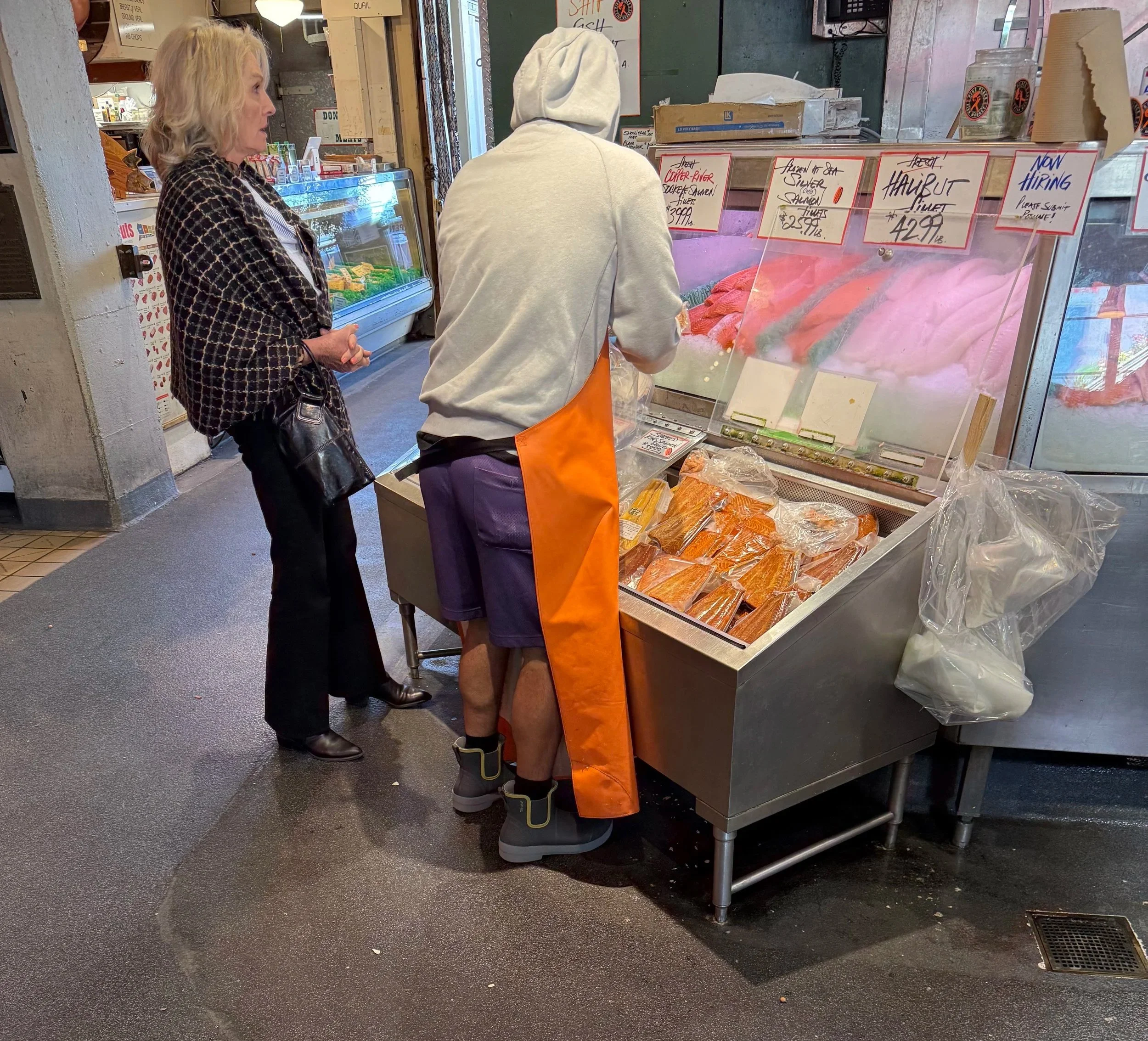 Fish Monger wearing Tahma low-cut boots at a fish market at Pikes Place in Seattl