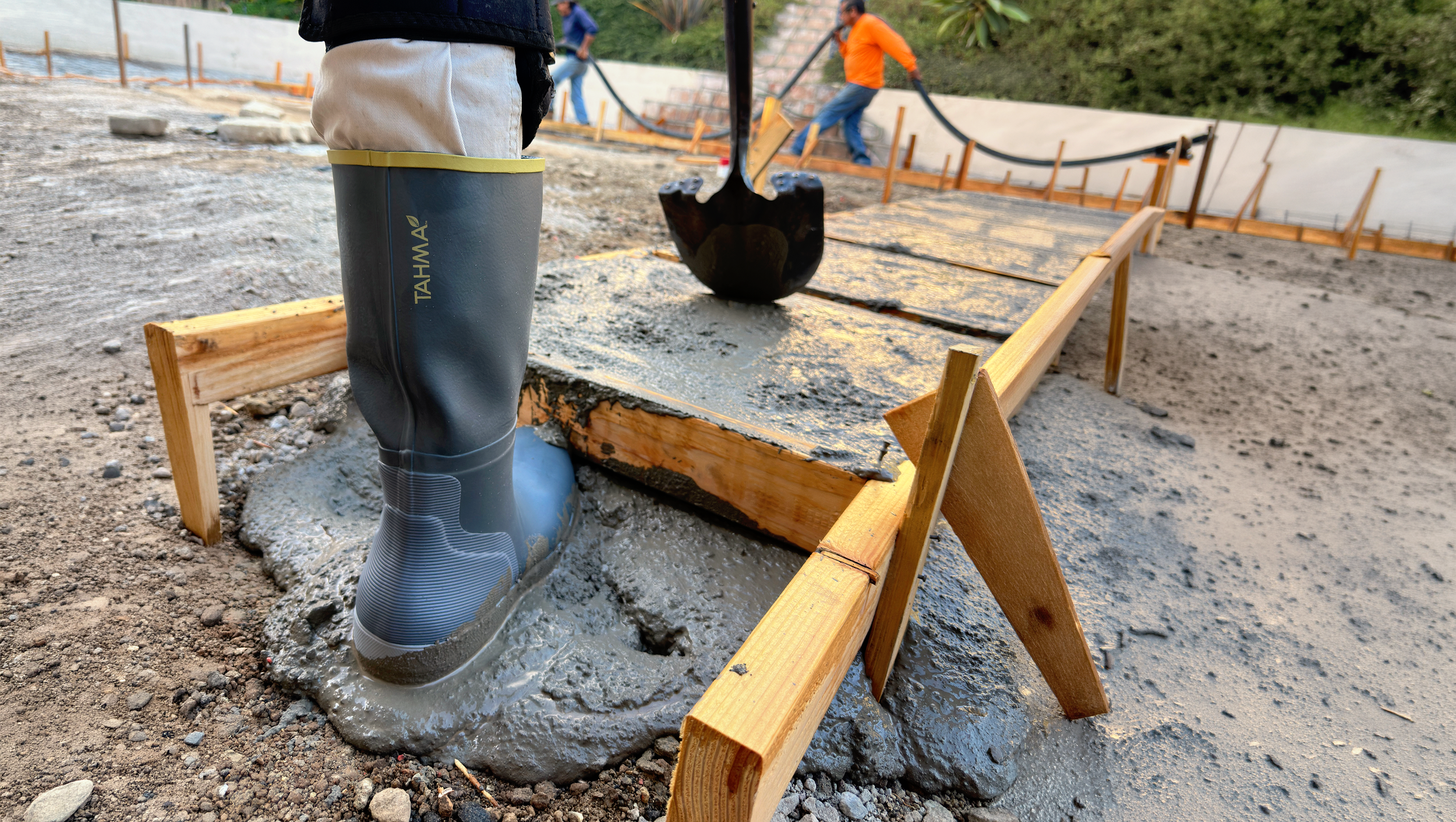 Tahma boots worn by a construction worker stepping in wet concrete