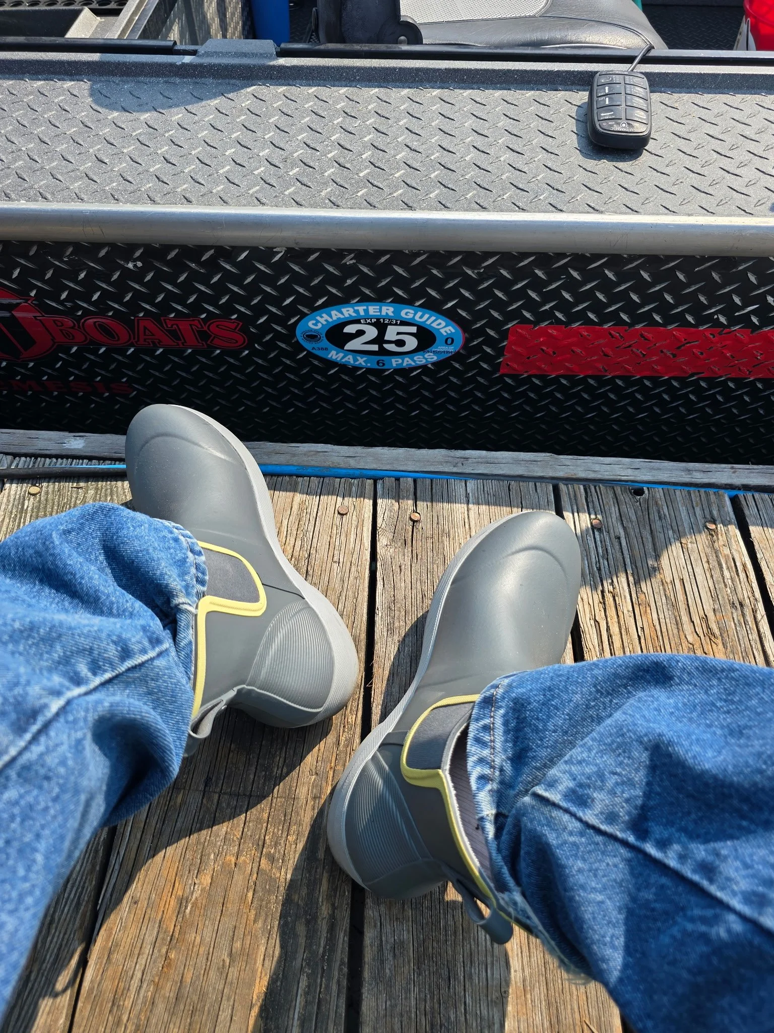 Customer wearing low-cut Tahma boots on a small fishing boat